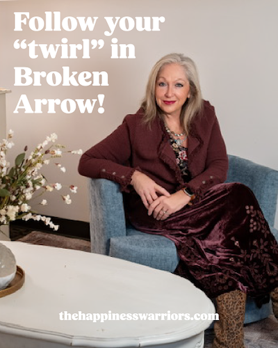 Loesch sitting in a chair, smiling at the camera, with text on the screen that reads, "Follow your twirl in Broken Arrow".